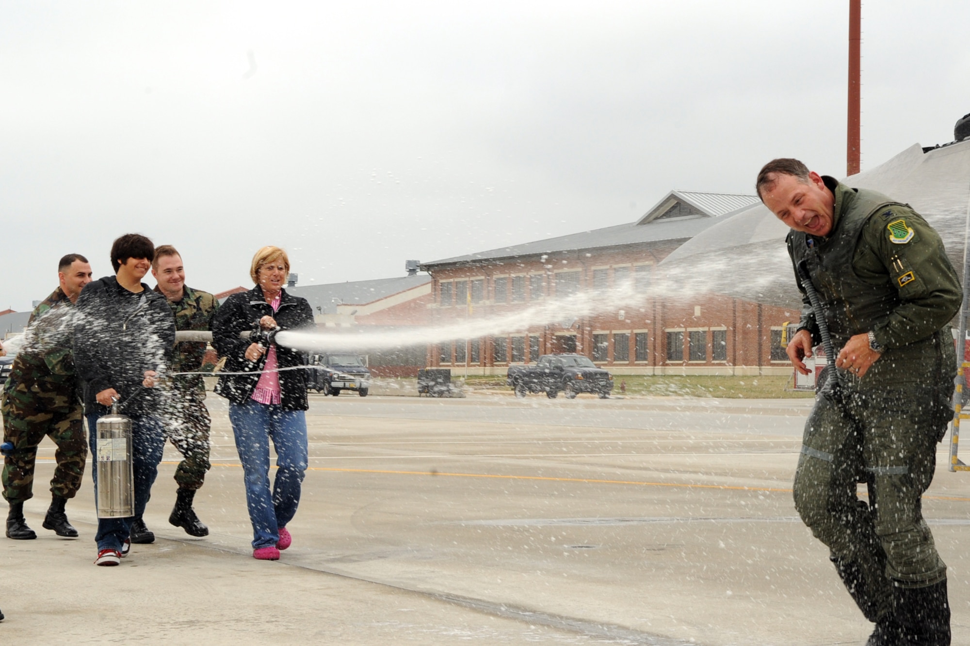 LANGLEY AIR FORCE BASE, Va.-- Col. Patrick "Dillon" Marshall, 1st Operations Group commander, is hosed down by family and co-workers in celebration of his return from his final flight here Nov. 7. A fini flight is the last flying mission for a commander before starting a new assignment. (U.S. Air Force photo/Airman 1st Class Jonathan Koob)