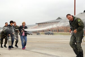 LANGLEY AIR FORCE BASE, Va.-- Col. Patrick "Dillon" Marshall, 1st Operations Group commander, is hosed down by family and co-workers in celebration of his return from his final flight here Nov. 7. A fini flight is the last flying mission for a commander before starting a new assignment. (U.S. Air Force photo/Airman 1st Class Jonathan Koob)