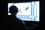 Capt. Sam Allen, 563rd Flying Training Squadron instructor and Unmanned Aerial Systems Unmanned Flight Course director, operates the controls of a battlespace simulator in the course's laboratory. The four-week UFC course begins Nov. 21. (U.S. Air Force photo by Rich McFadden) 