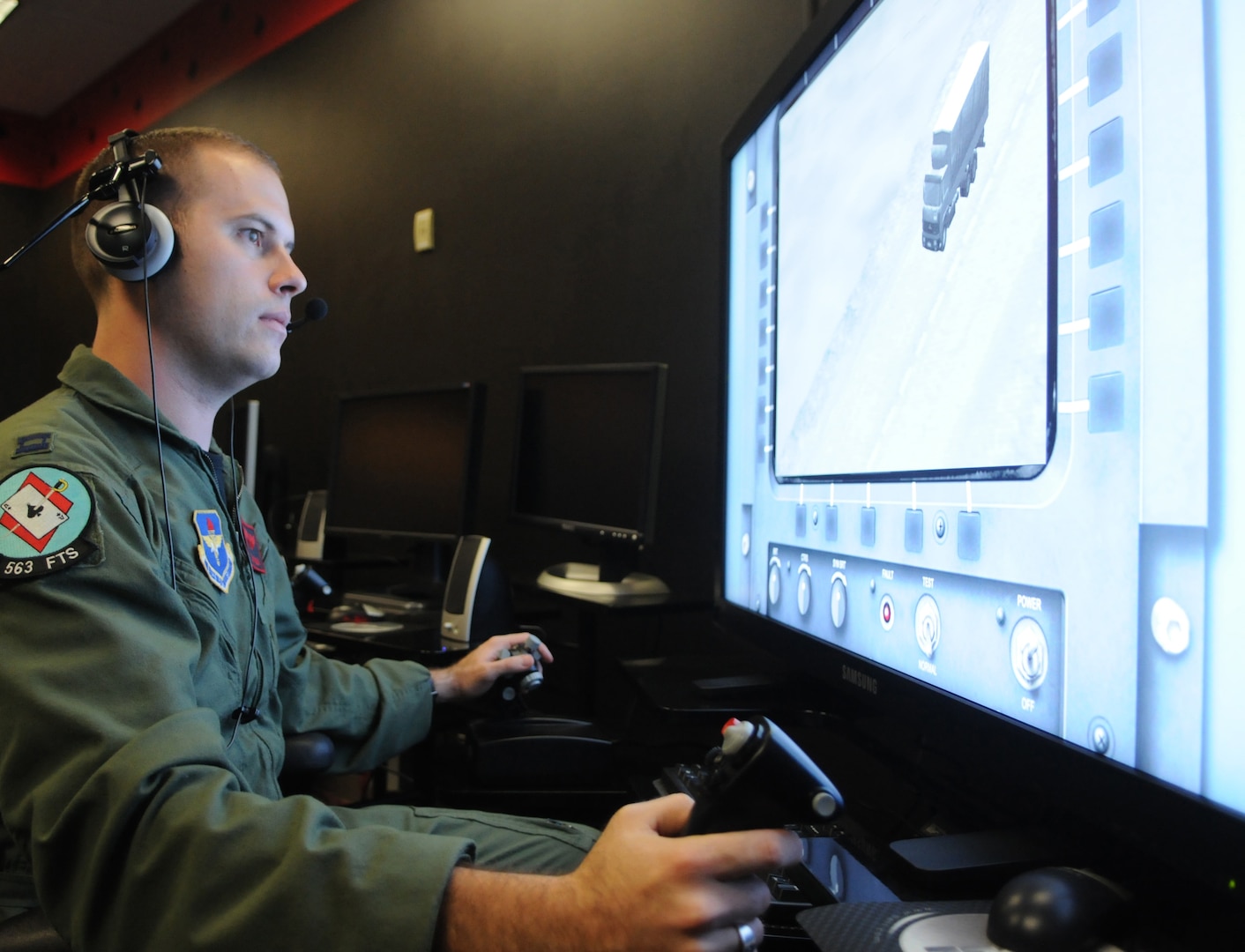 Capt. Sam Allen, 563rd Flying Training Squadron instructor and Unmanned Aerial Systems Unmanned Flight Course director, operates the controls of a battlespace simulator in the course's laboratory. The four-week UFC course begins Nov. 21. (U.S. Air Force photo by Rich McFadden) 
