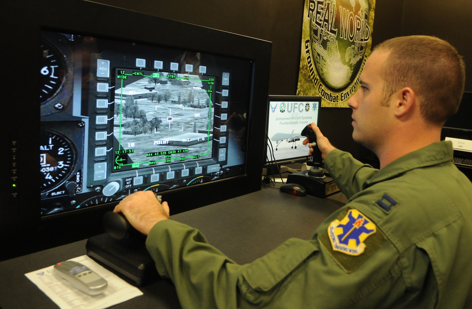 Capt. Sam Allen, 563rd Flying Training Squadron instructor and Unmanned Aerial Systems Unmanned Flight Course director, operates the controls of a battlespace simulator in the course's laboratory. The four-week UFC course begins Nov. 21. (U.S. Air Force photo by Rich McFadden) 