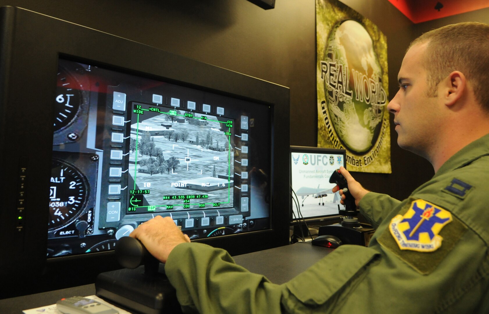 Capt. Sam Allen, 563rd Flying Training Squadron instructor and Unmanned Aerial Systems Unmanned Flight Course director, operates the controls of a battlespace simulator in the course's laboratory. The four-week UFC course begins Nov. 21. (U.S. Air Force photo by Rich McFadden) 