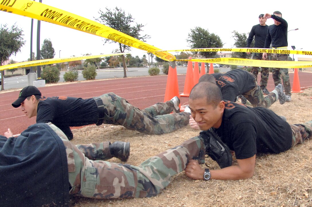 Members of the 60th Logistics Readiness Squadron Team 2, Airman 1st Class Carlos Aguilar, left, and 2nd Lt. Roly Gavina, right, contend with the obstacle course during the Travis SWAT Team Competition. (USAF photo by Civ/ Nan Wylie)