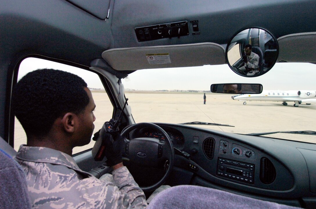 Senior Airman Anthony Mason, 89th Aerial Port Squadron passenger service agent, awaits instruction from the dispatcher prior to a distinguished visitor departure. (U.S. Air Force photo by Bobby Jones)