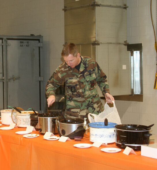 WRIGHT-PATTERSON AFB, Ohio - Master Sgt. Timothy Back, 445th Communications Flight, checks on his chili entry during the 445th Airlift Wing's Annual Chili Cook-off.  Sergeant Back was the first place winner, Tech. Sgt. Robin Spurlock, 445th Mission Support Flight, was the second place winner, and Lt. Col. Jennifer Wedel, 445th Aeromedical Evacuation Squadron placed third.  The annual cook-off is a fundraiser for the Combined Federal Campaign.  The wing's goal this year $13,000. (Air Force photo/Laura Darden)