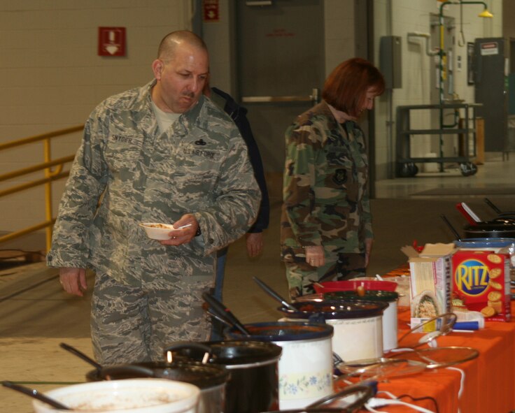 WRIGHT-PATTERSON AFB, Ohio - Senior Master Sgt. Monte Snyder, 445th Maintenance Operations Flight, has a tough decision to make as he decides which chili to taste at the 445th Airlift Wing's Annual Chili Cook-off.  The annual cook-off is a fundraiser for the Combined Federal Campaign.  The wing's goal this year $13,000. (Air Force photo/Laura Darden)