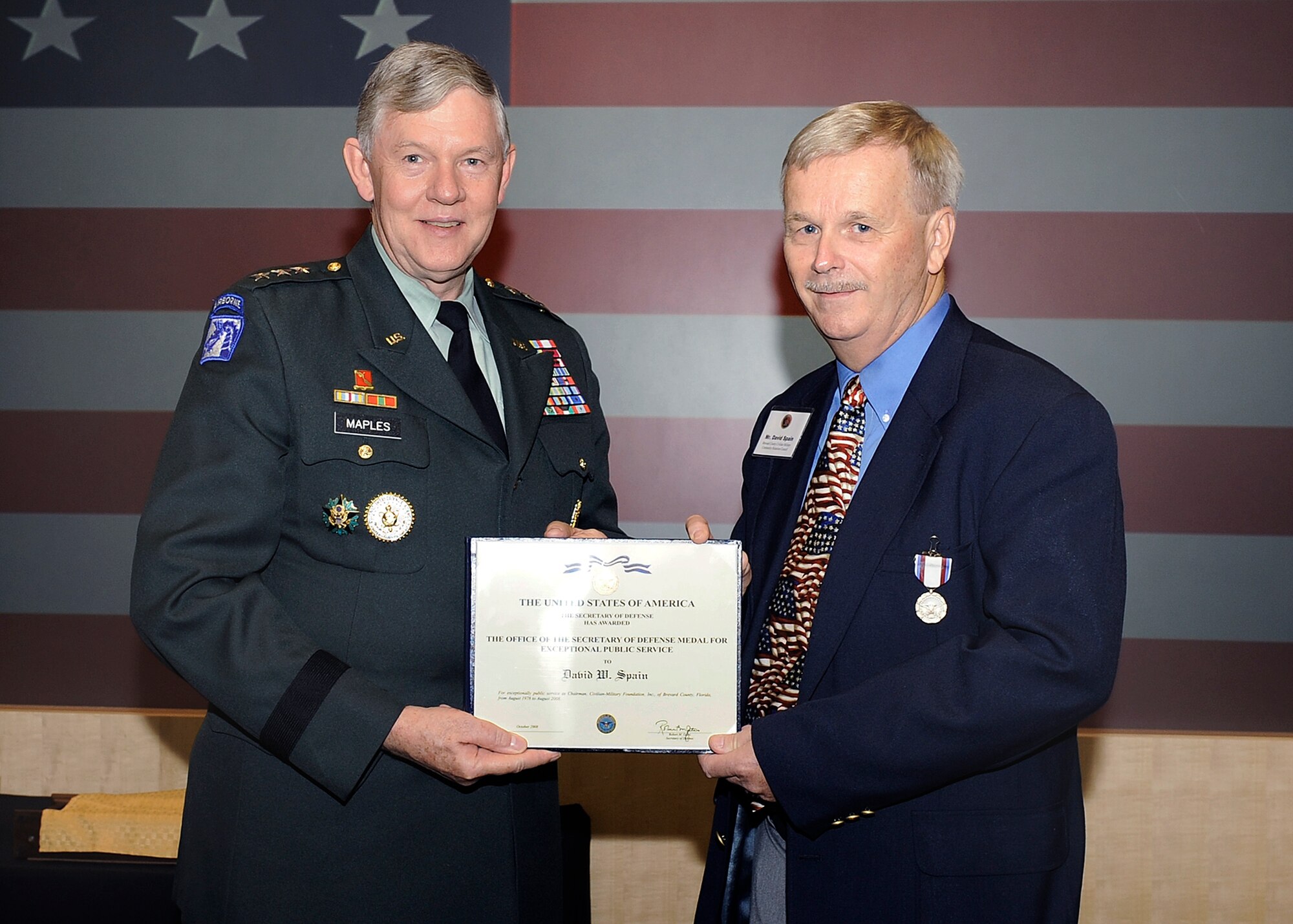 Brevard County Civilian Military Community Relations Council volunteer Dave Spain receives his Exceptional Public Service Award from Defense Intelligence Agency Director Army Lt. Gen. Michael Maples Oct. 16 in a Washington, D.C. ceremony. Mr. Spain has given 30 years of volunteer support to his local military community. (Defense Intelligence Agency photo by Gary Fike)