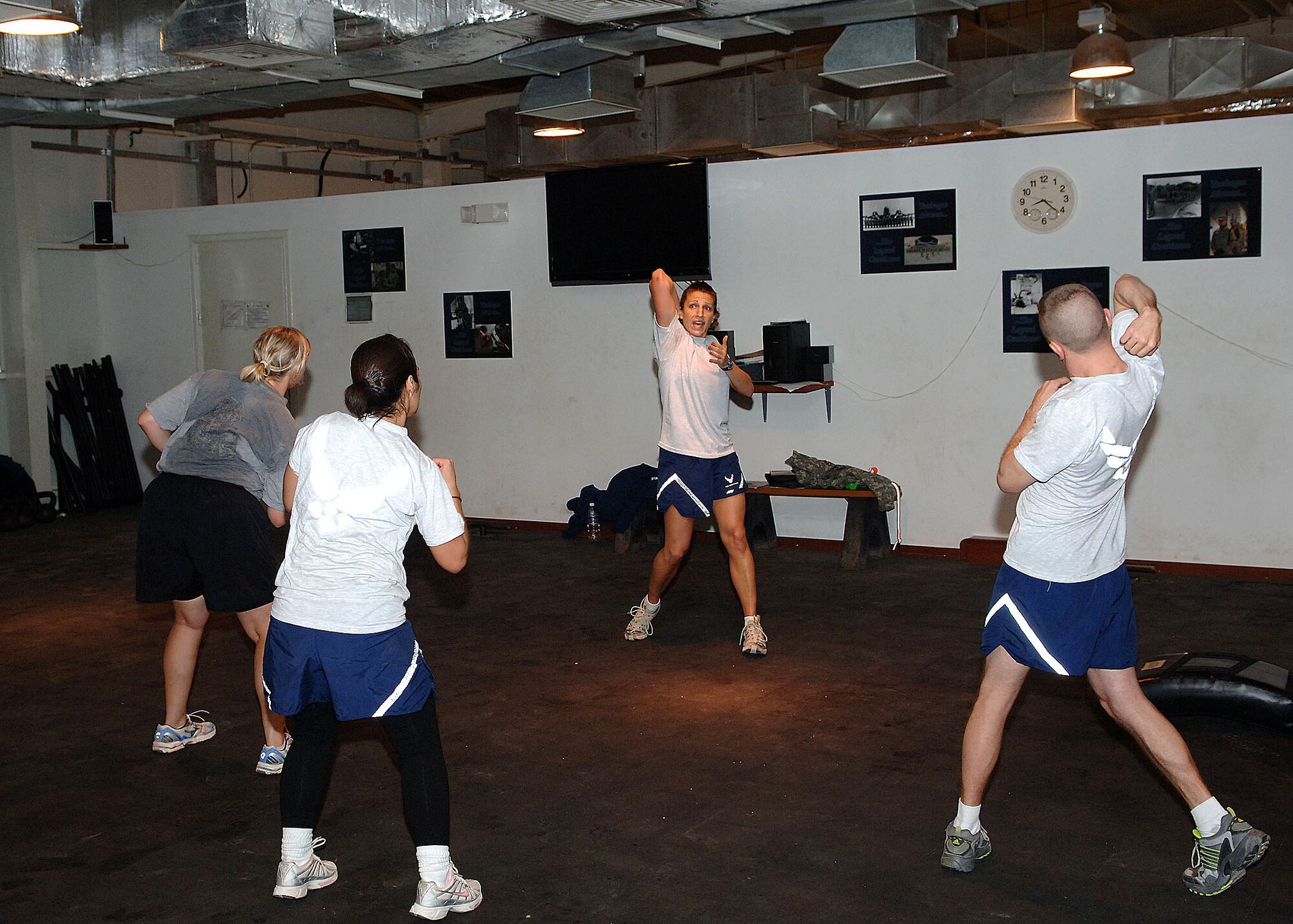 Staff Sgt. Brooke Alf (background) demonstrates a Krav Maga offense move to students at the Joint Base Balad Red Tail Fitness Center Nov. 5. Alf, a health services management journeyman assigned to the 332nd Expeditionary Aerospace Medical Squadron, volunteers to teach the self-defense class on her free time. She is a native of Pittsfield, Ill., deployed from the 59th Medical Wing at Lackland Air Force Base, Texas. (U.S. Air Force photo/Tech. Sgt. Rich Lisum)