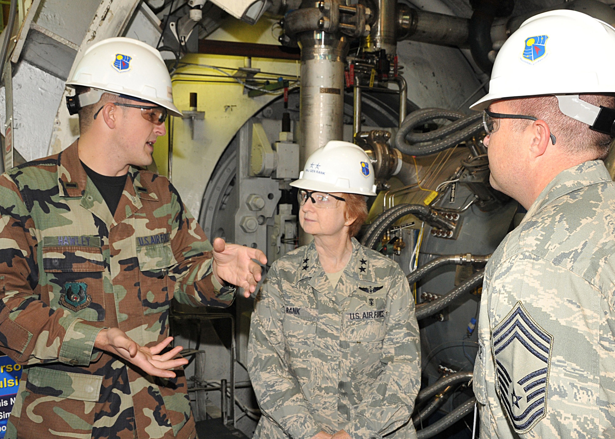 1st Lt. Ryan Hawley, project engineer in the 718th Test Squadron, explains the Aerodynamic and Propulsion Test Unit (APTU) facility to Maj. Gen. Melissa Rank and Chief Master Sgt. Joseph Potts during their tour of AEDC facilities. (Photo by David Housch)
