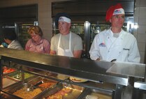 In addition to the customary going-away party, Chief Master Sgt. Rocky Hart, 919th Special Operations Wing command chief, insisted the day include service to his Airmen - literally - during a unit training assembly. For nearly two hours Sunday, he served hot meals to Airmen at the base dining facility, all the while wishing them well and offering last-minute mentorship. Chief Hart now moves on to assume the command chief role for the 310th Space Wing (Reserve) at Schriever Air Force Base, Colo. (U.S. Air Force Photo\Senior Airman Jon McCallum)