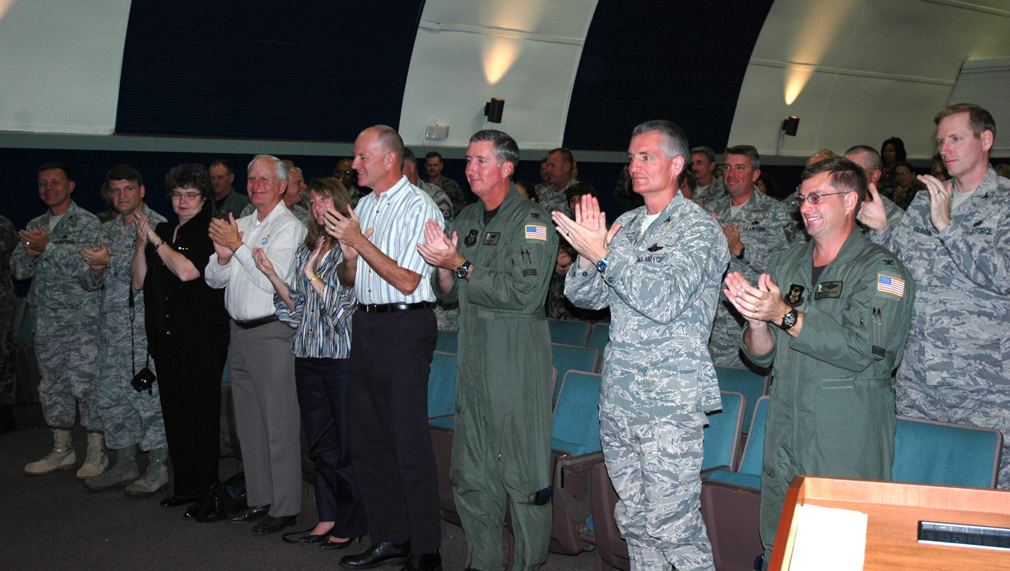 Chief Master Sergeant Rocky Hart, 919th Special Operations Wing command chief, receives a standing ovation from men and women of Duke Field at the base theater. Chief Hart was honored on his final duty day during the unit training assembly. The chief now moves on to assume the command chief role for the 310th Space Wing (Reserve) at Schriever Air Force Base, Colo. (U.S. Air Force Photo\Senior Airman Jon McCallum)
