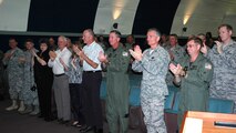 Chief Master Sergeant Rocky Hart, 919th Special Operations Wing command chief, receives a standing ovation from men and women of Duke Field at the base theater. Chief Hart was honored on his final duty day during the unit training assembly. The chief now moves on to assume the command chief role for the 310th Space Wing (Reserve) at Schriever Air Force Base, Colo. (U.S. Air Force Photo\Senior Airman Jon McCallum)