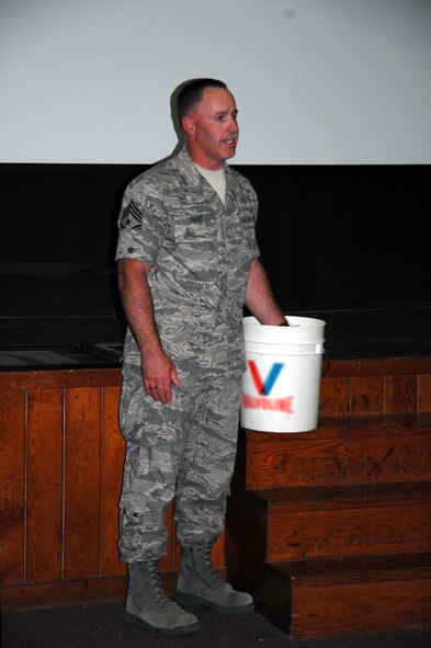 During a light-hearted going away ceremony for Chief Master Sgt. Rocky Hart, 919th Special Operations Wing command chief, members speaking were encouraged to place their hand in a bucket of ice in order to motivate short speeches and allow time for all speakers and presentations. Chief Hart stepped up to the challenge placing his own hand in the ice while he spoke. Chief Hart now moves on to assume the command chief role for the 310th Space Wing (Reserve) at Schriever Air Force Base, Colo. (U.S. Air Force Photo\Senior Airman Jon McCallum)