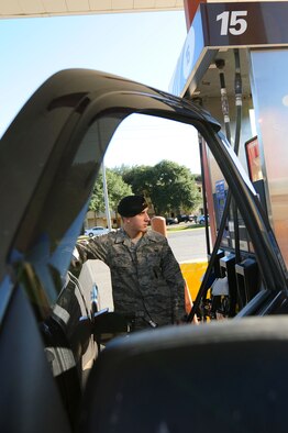 BARKSDALE AIR FORCE BASE, La.-- Airman 1st Class Kyle Boyer, 2d Security Forces Squadron, fills up with gas after using his Military Star Card at the Shoppette Oct. 28. Using the Military Star Card on base will save patrons an additional $.03 per gallon. (U.S. Air Force photo by Airman 1st Class Joanna M. Kresge)
