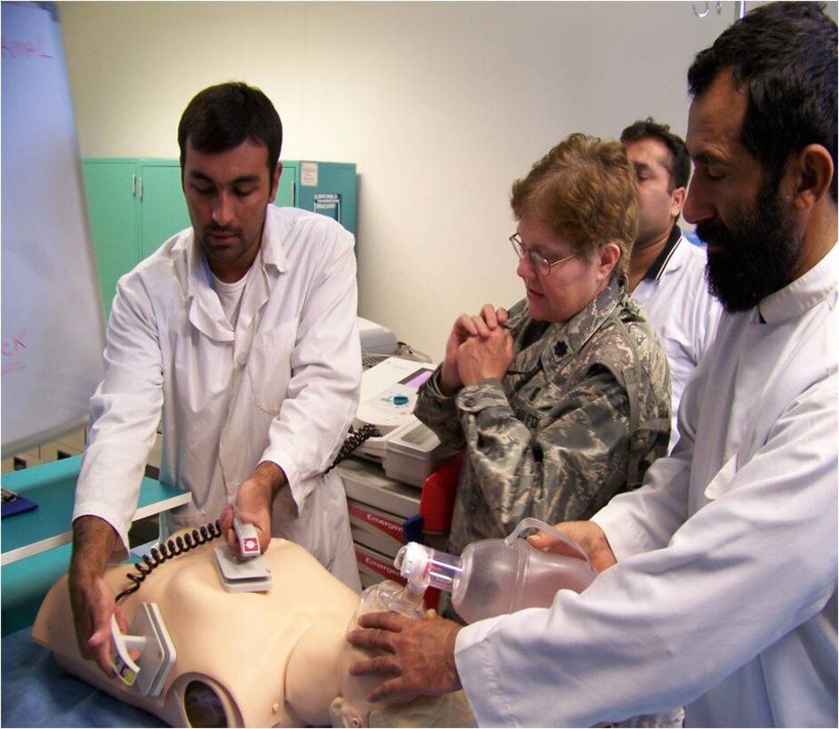 Lt. Col. Susan Bassett, the chief nurse at the 882nd Training Group, helps Afghan nurses demonstrate how to defibrillate a patient who is in cardiac arrest during a 365-day deployment to the 205th Afghan Regional Security Integration Command in Kandahar, Afghanistan. (U.S. Air Force photo) 