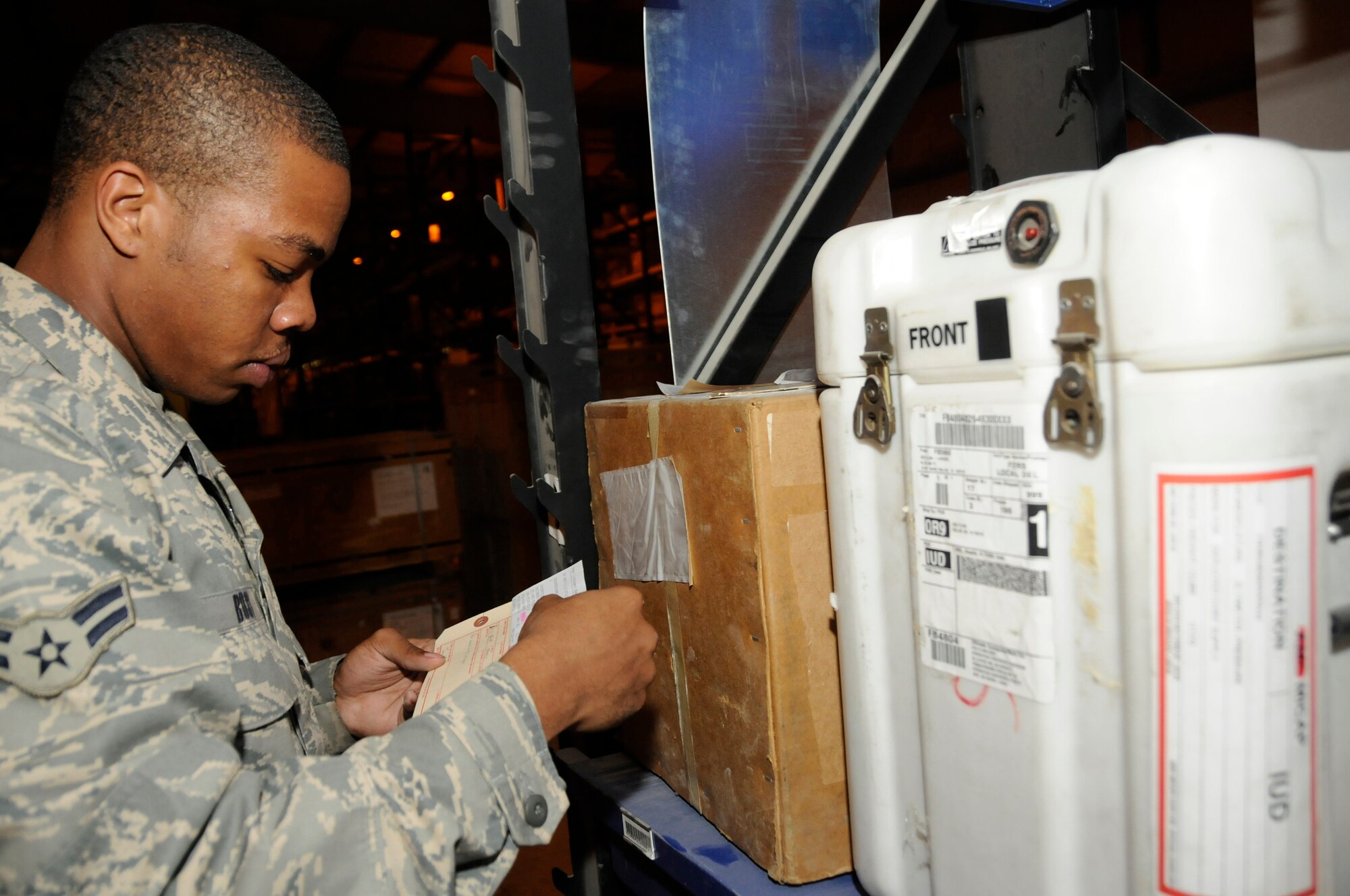 Airman 1st Class Marcus Bostic, flight service center apprentice assigned to the 379th Expeditionary Logistics Readiness Squadron, in checks unserviceable aircraft parts by matching stock numbers and part numbers Nov. 6, at an undisclosed air base in Southwest Asia.  Airman Bostic, a native of Cincinnati, Ohio, is deployed from Moody Air Force Base, Ga., in support of Operations Iraqi and Enduring Freedom and Joint Task Force-Horn of Africa. (U.S. Air Force photo by Staff Sgt. Darnell T. Cannady/Released)