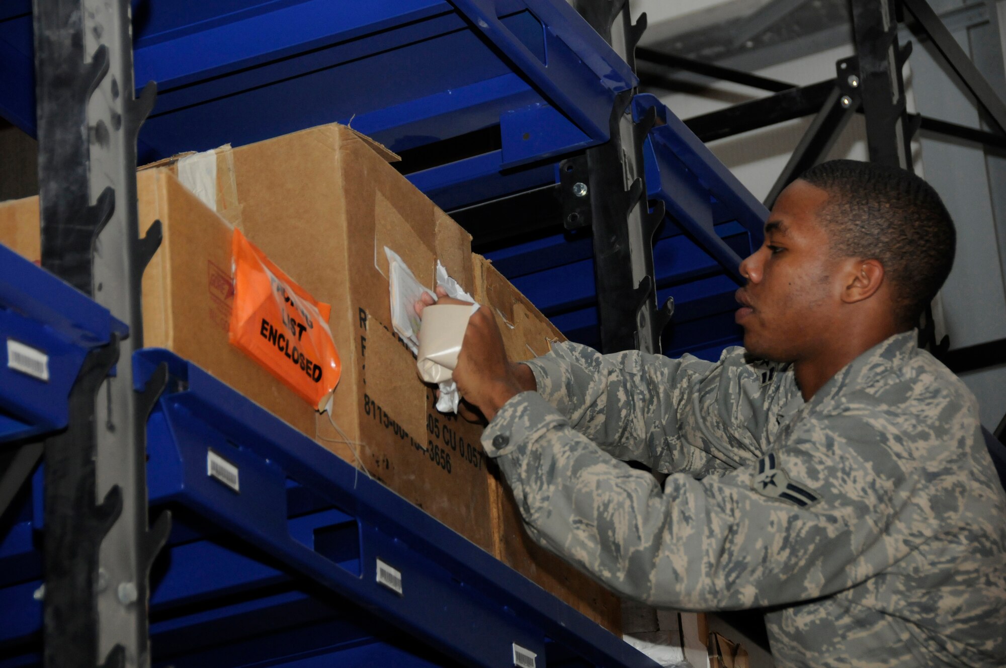 Airman 1st Class Marcus Bostic, flight service center apprentice assigned to the 379th Expeditionary Logistics Readiness Squadron, in checks unserviceable aircraft parts by matching stock numbers and part numbers Nov. 6, at an undisclosed air base in Southwest Asia.  Airman Bostic, a native of Cincinnati, Ohio, is deployed from Moody Air Force Base, Ga., in support of Operations Iraqi and Enduring Freedom and Joint Task Force-Horn of Africa. (U.S. Air Force photo by Staff Sgt. Darnell T. Cannady/Released)