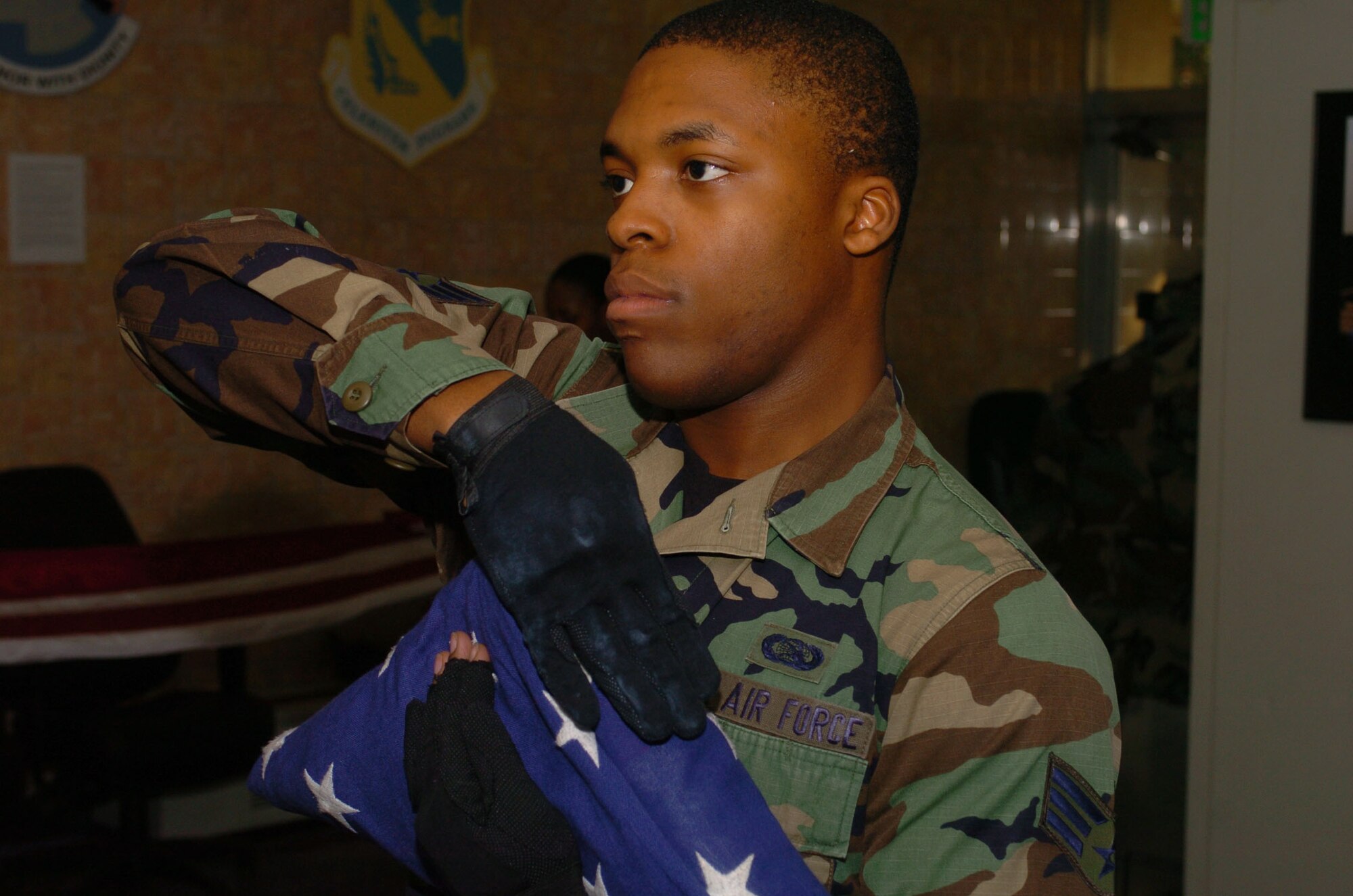 Senior Airman Matthew Yard from the 374th Communications Squadron practices the folding of the flag ceremony during Honor Guard practice. The folding of the Flag ceremony is usually performed at retirement ceremonies.(U.S. Air Force photo by Airman Devin Doskey)