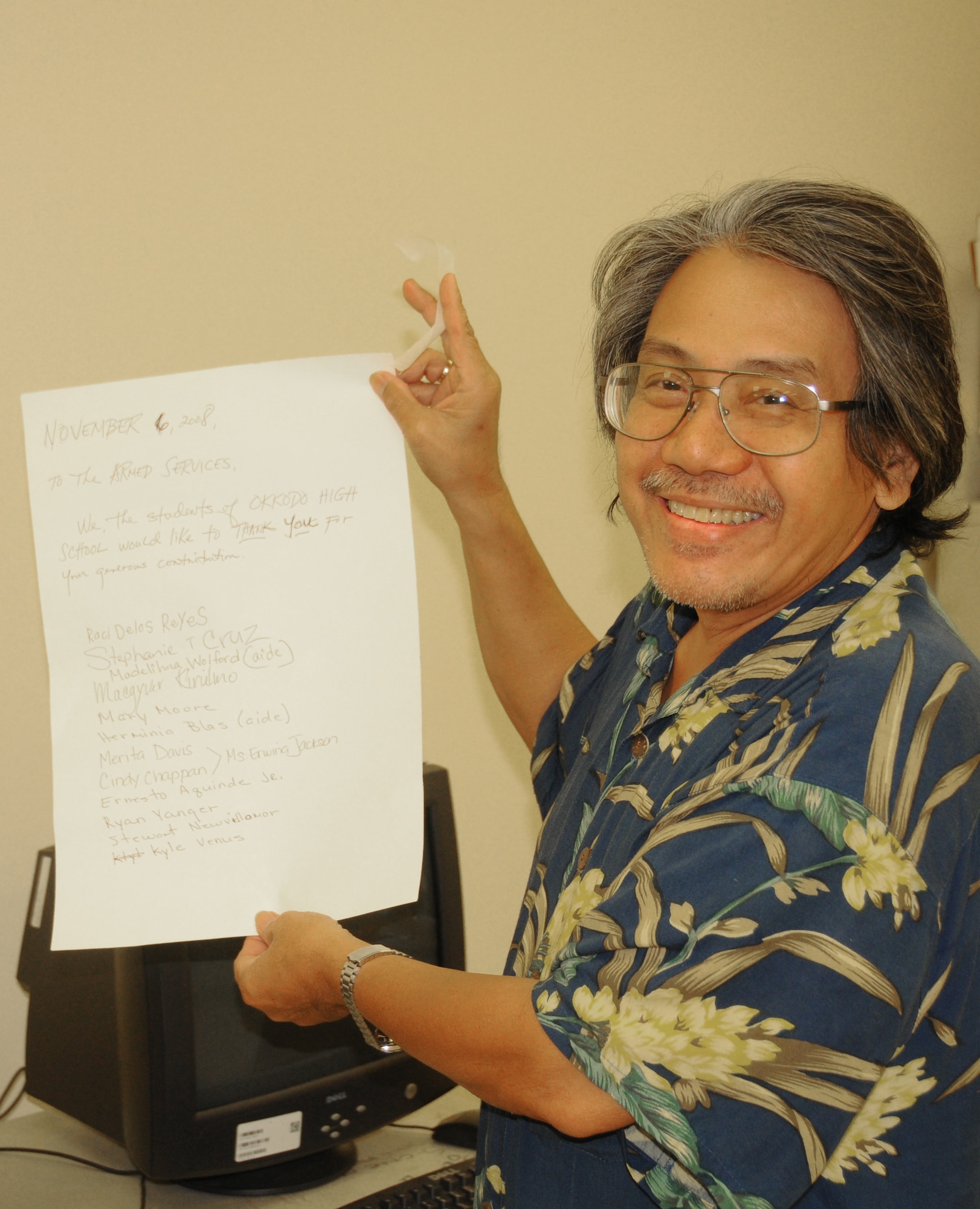 ANDERSEN AIR FORCE BASE, Guam - Remo Gajo, a teacher at Okkado High School holds up a thank you letter written and signed by students, teachers and staff, for the computers donated by Andersen AFB to their classroom Nov. 4 in Dededo, Guam.  (U.S. Air Force photo by Staff Sgt. Jamie Lessard)
