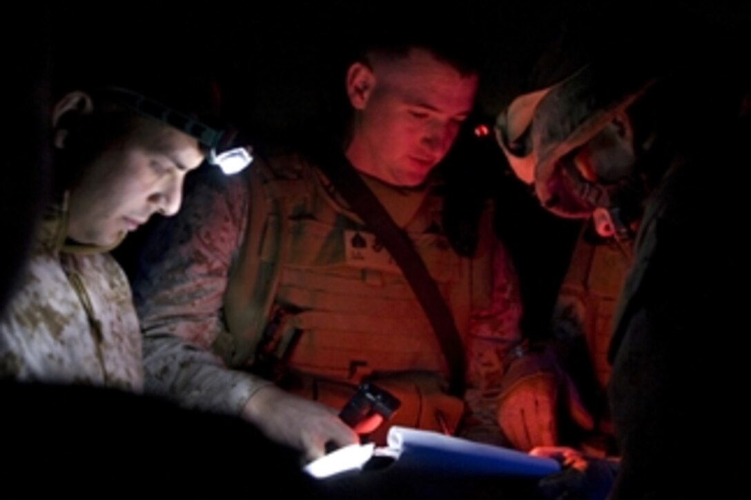 U.S. Marine Corps Sgt. Charlie Peek, administration noncommissioned officer with Headquarters and Service Company, 1st Battalion, 3rd Marine Regiment, Regimental Combat Team 1, reviews a passenger manifest at Camp Fallujah, Iraq, on Nov. 2, 2008.  The Marines and Iraqi security forces used air and ground transport to conduct a joint operation north of their area of operation.  