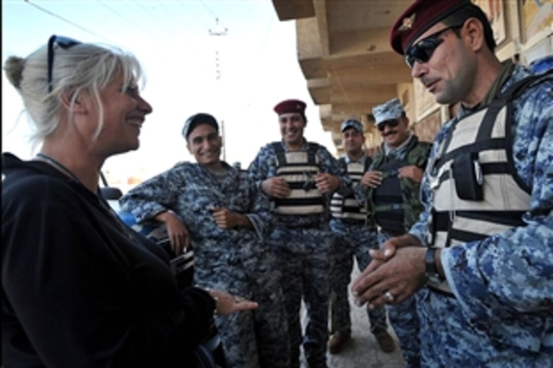 Betsy Hiel, a journalist with the Pittsburgh Tribune Review, meets with Iraqi soldiers and policemen at National Police Headquarters 172, located in the Doura community of southern Baghdad, Iraq, Nov. 3, 2008.