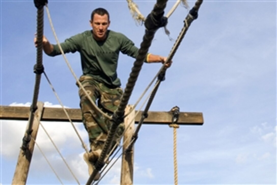 Champion cyclist Lance Armstrong crosses a rope bridge during a visit to the Naval Special Warfare Center at Naval Amphibious Base Coronado, Calif., Nov. 4, 2008. Armstrong toured the facility and completed the Basic Underwater Demolition/SEALs obstacle course.
