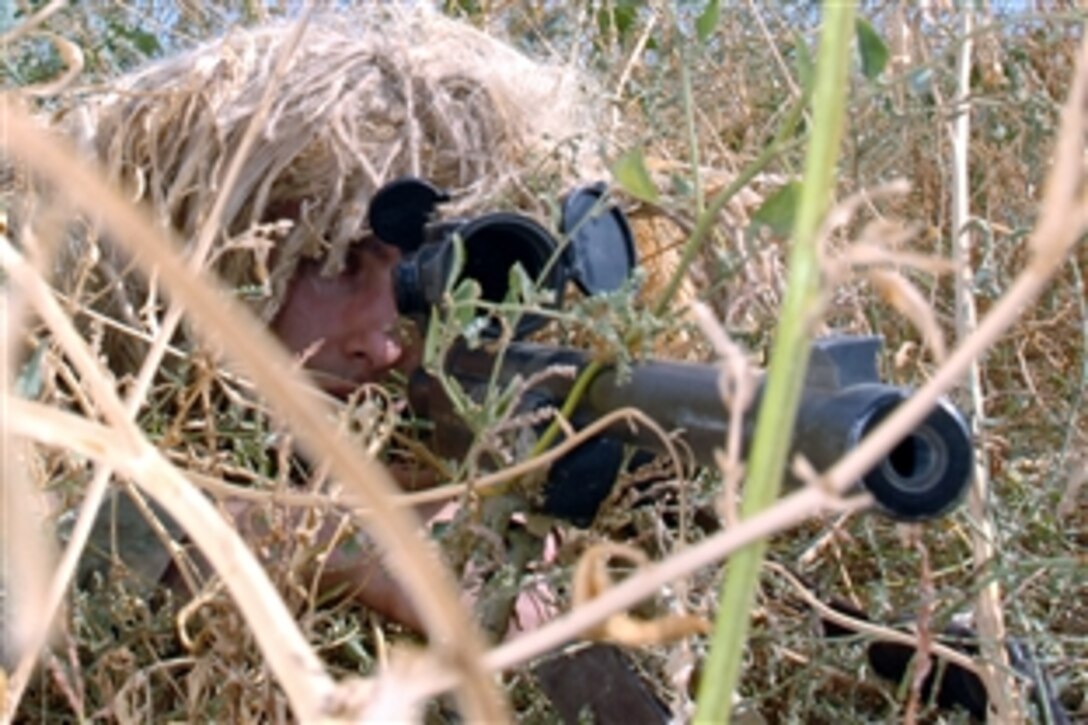 U.S. Air Force Airman 1st Class Joseph Curran keeps a close eye on activities outside the wire on Kirkuk Regional Air Base, Iraq, Oct. 27, 2008. Curran is assigned to the 506th Expeditionary Security Forces Squadron, a close precision engagement team that provides enhanced observation for base defense.