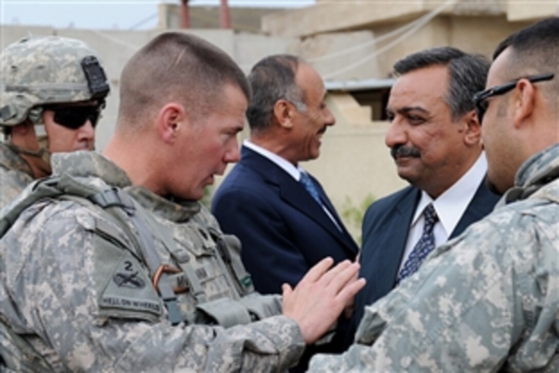 U.S. Army Lt. Col. McKenna assigned to the 2nd Brigade Combat Team, 1st Armored Division, talks to district generals for the city of Solomon Pak, Iraq,, Oct. 31, 2008, after a meeting to discuss local agriculture.