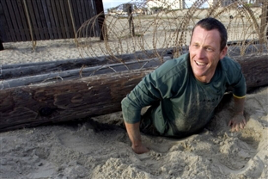 Champion cyclist Lance Armstrong participates in a Basic Underwater Demolition/SEALs obstacle course at the Naval Special Warfare Center at Naval Amphibious Base Coronado, Calif., Nov. 4, 2008, while touring the facility.