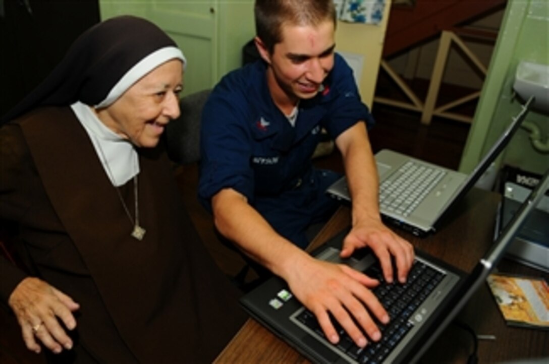 U.S. Navy Petty Officer 2nd Class Andrew Bryson, assigned to the amphibious assault ship USS Kearsarge (LHD 3), teaches Sister Helena of the Carmelite Sister Convent how to use the internet in Belmont, Trinidad and Tobago, on Nov. 3, 2008.  The Kearsarge is deployed in support of the Caribbean phase of the humanitarian and civic assistance mission Continuing Promise 2008, an equal-partnership mission involving the United States, Canada, the Netherlands, Brazil, Nicaragua, Colombia, Dominican Republic, Trinidad and Tobago and Guyana.  