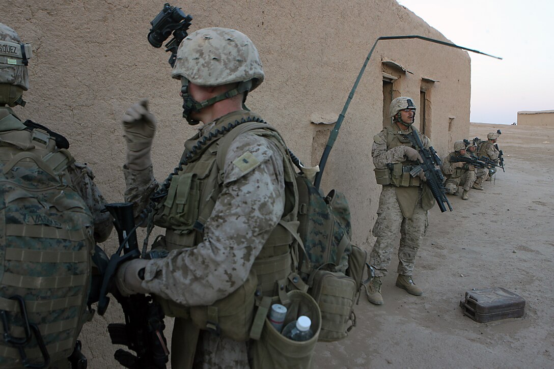 Military Police with Combat Logistics Company 19, 1st Marine Logistics Group, pause their patrol and set up security while patrol leaders plan the next move here Nov. 9. The Marines of the Military Police detachment here began their first security and reconnaissance patrol in Iraq’s northern Nineweh Province Nov. 9. The MPs, shoulder the task of base security here, which includes presence patrols through adjacent towns and abandoned structures. Their mission Nov. 9 was to clear out and secure an old, abandoned town located just a kilometer west of Camp Sinjar. As insurgent activity continues in Mosul, a city located East of Sinjar, Marine presence in smuggler jump off points and safe havens serves to choke off possible enemy supply routes. The MPs are just one part of the first Marine Air Ground Task Force outside Anbar in Iraq since 2004. They traveled to the Nineweh province to kick off Operation Defeat Al Qaeda in the North II, an operation aimed at stamping out the insurgency just west of the restive city of Mosul.