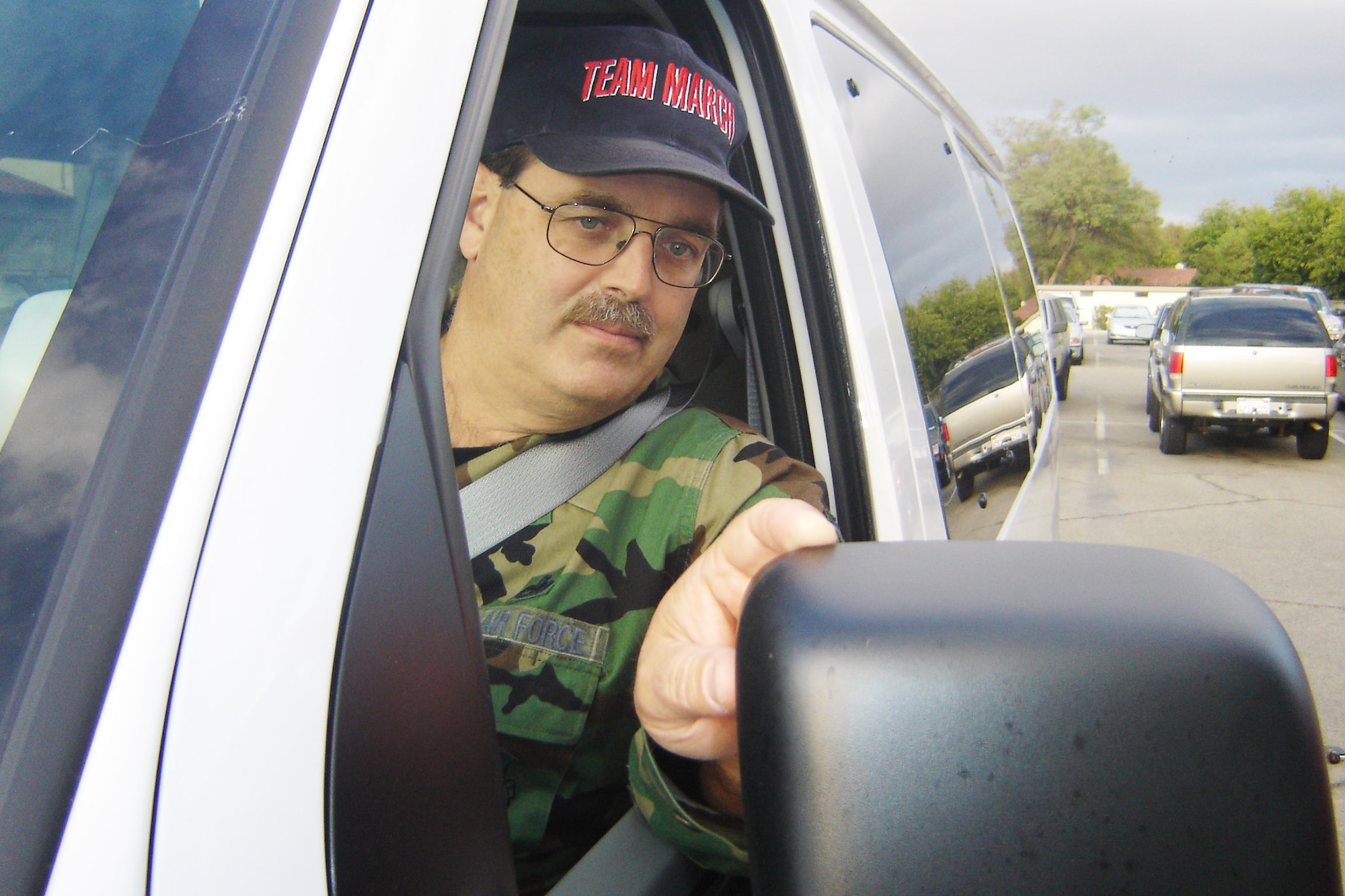 Master Sgt. Joseph Vitelli, 452 MXG/QA, adjusts his mirror shortly before picking up members of his Vanpool, Tuesday, for the ride home to Temecula from March ARB. The base took delivery of the brand new eight-passenger Ford E-350 van, Oct. 29,  after Sergeant Vitelli and others gathered enough riders for the money-saving trip. The pool took its maiden ride on Monday. Sergeant Vitelli, the pool’s primary driver, said the van is full, but if more wanted to join, getting a larger van is possible. ( U.S. Air Force photo by Will Alexander)
