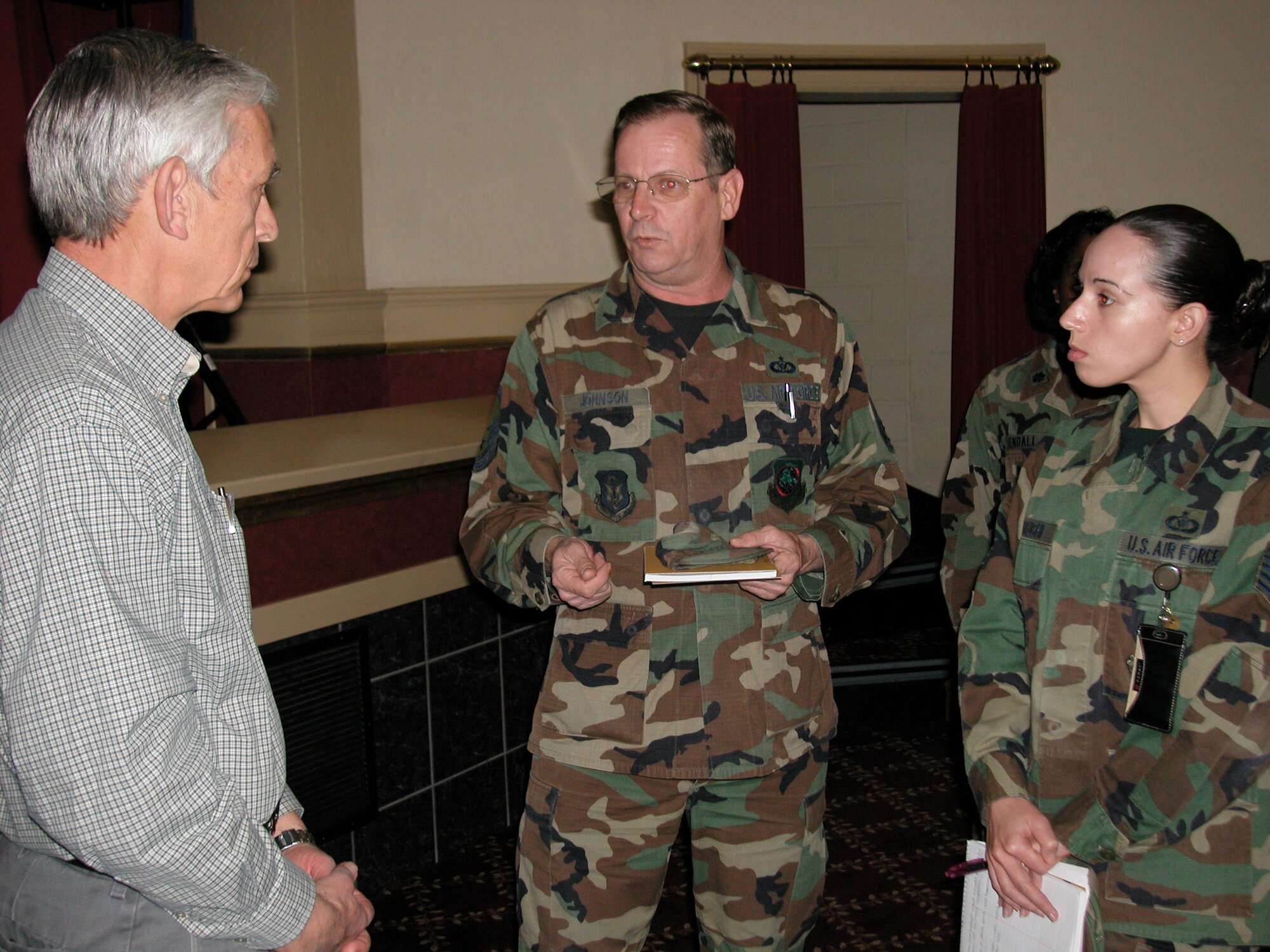 Mr. Craig Duehring, Assistant Secretary of the Air Force for Manpower and Reserve Affairs, talks with Master Sgt. Jeff Johnson and Tech. Sgt. Tianna Yamauchi, 452 AMW, after the Town Hall meeting in the Cultural Resources Center, Wednesday. Mr. Duehring said he was proud to serve with the Guard and Reserve, and said he is impressed with the dedication of those members who give up weekends, family time, and take leave from civilian employment to accomplish the mission. He acknowledged that the budget will be a key issue next year, and the Air Force will have challenges ahead as our mission evolves. March Air Reserve Base was the last base he will visit during his tenure in his current position. (U.S. Air Force photo by SrA Desiree Economides)