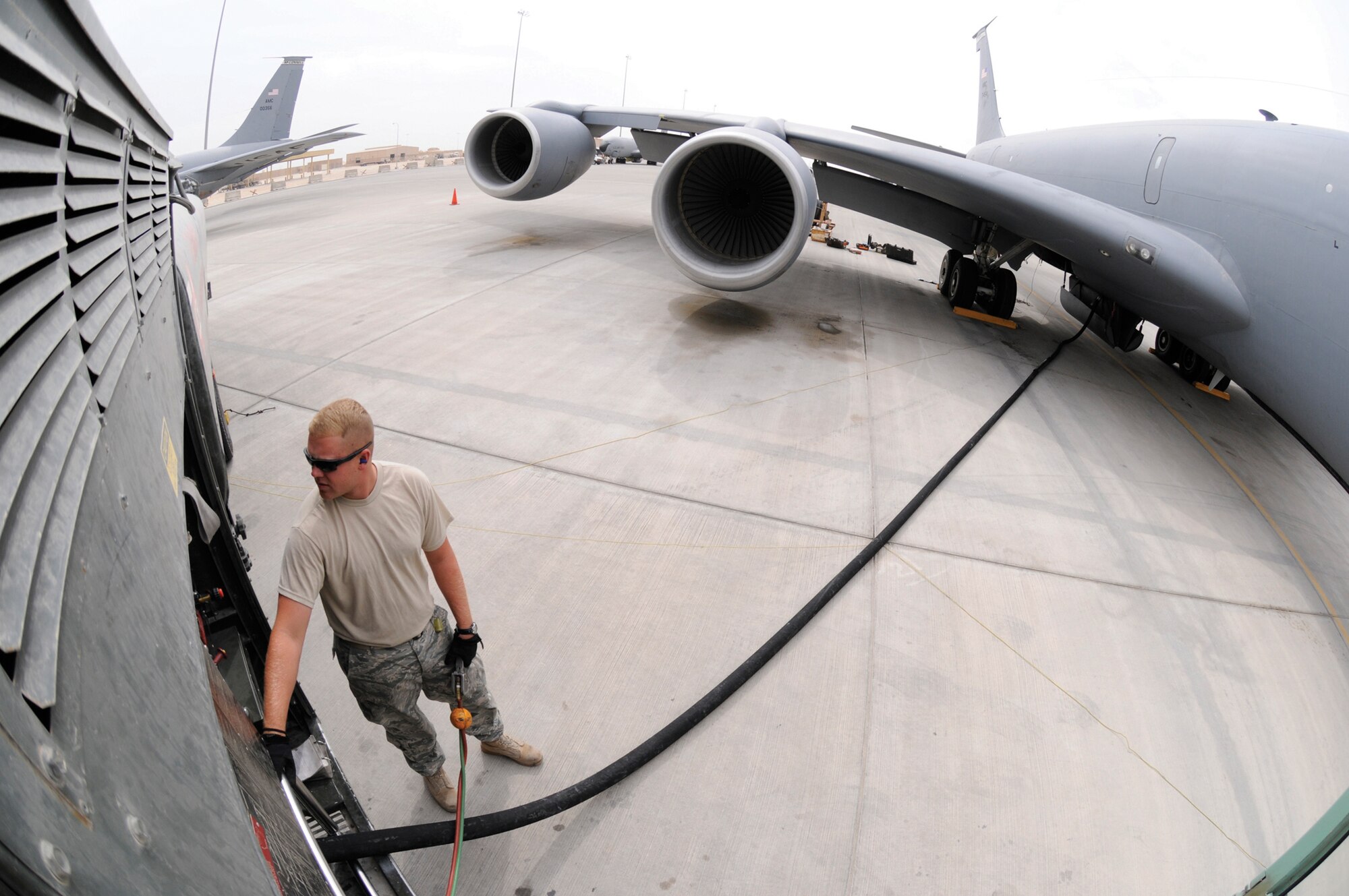 Airman 1st Class Bradley Dean, fuels apprentice assigned to the 379th Expeditionary Logistics Readiness Squadron, checks over the gauges on his fuel truck while fueling a KC-135 Stratotanker, Nov. 4, 2008, at an undisclosed air base in Southwest Asia.  He keeps his attention on the crew chief of the aircraft and the gauges on his fuel truck.  Depending on the mission the KC-135 can hold four or five fuel trucks worth of fuel. Airman Dean is a native of Tennessee Colony, Texas, and deployed from Moody Air Force Base, Ga. (U.S. Air Force photo by Tech. Sgt. Michael Boquette)