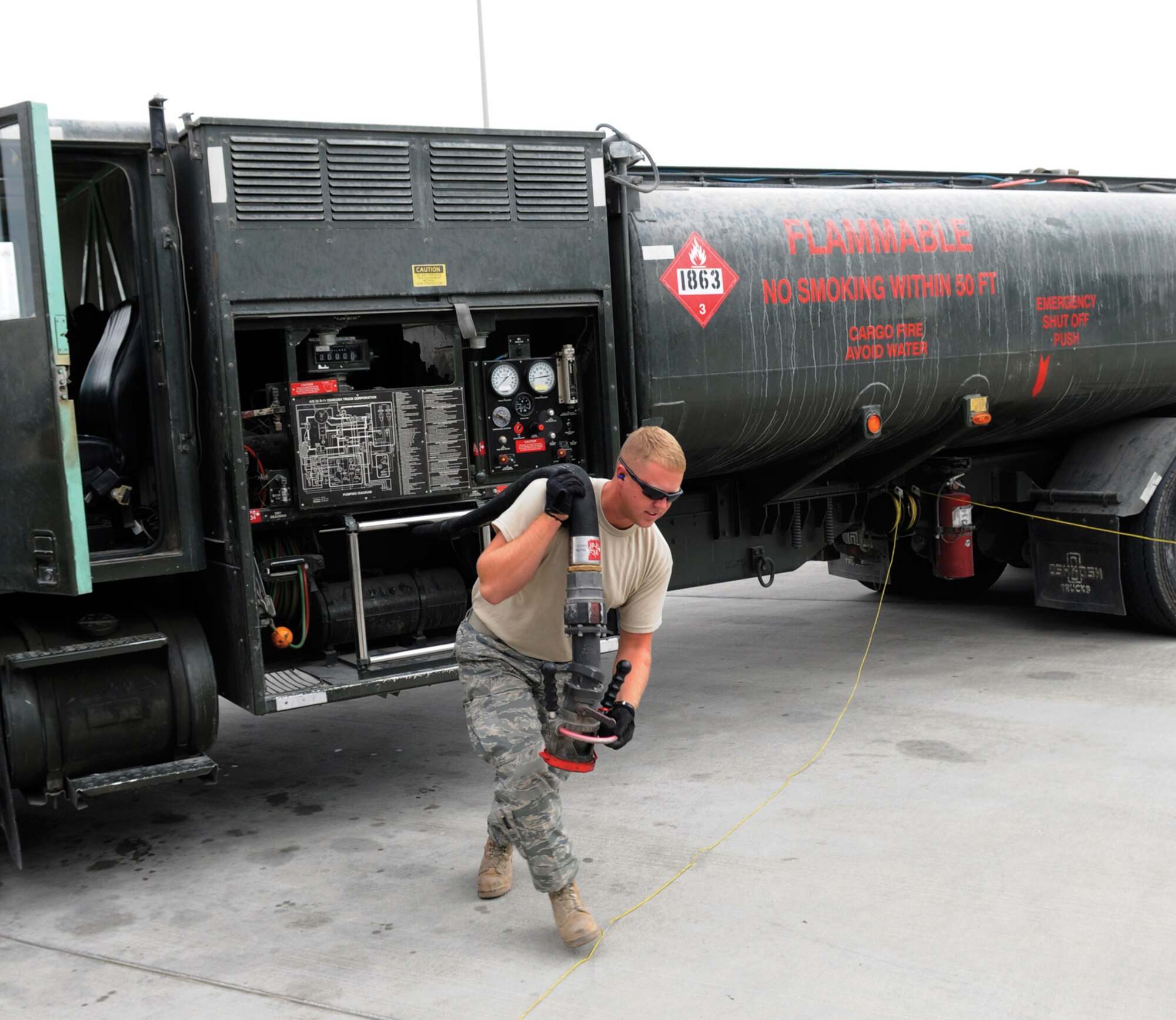 Airman 1st Class Bradley Dean, fuels apprentice assigned to the 379th Expeditionary Logistics Readiness Squadron, unreels his fuel hose prior to fueling a KC-135 Stratotanker, Nov. 4, 2008, at an undisclosed air base in Southwest Asia.  Airman Dean is a native of Tennessee Colony, Texas, and deployed from Moody Air Force Base, Ga., in support of Operations Iraqi and Enduring Freedom and Joint Task Force-Horn of Africa.  (U.S. Air Force photo by Tech. Sgt. Michael Boquette/Released)