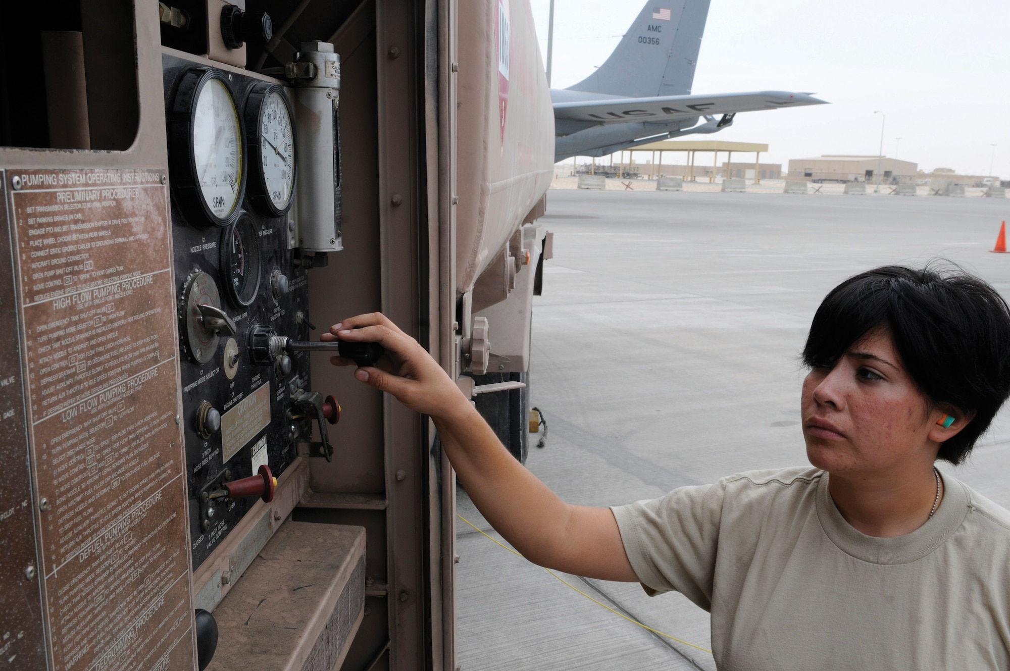 Airman 1st Class Angelica Gonzalez, fuels apprentice assigned to the 379th Expeditionary Logistics Readiness Squadron, slows down the flow of fuel Nov. 4, at an undisclosed location in Southwest Asia.  She carefully controls the speed of fuel leaving her fuel truck and entering the KC-135 Stratotanker. Depending on the mission the KC-135 can hold four or five fuel trucks worth of fuel. Airman Gonzalez is a native of Scotts Bluff, Neb., and deployed from Kadena Air Base, Japan, in support of Operations Iraqi and Enduring Freedom and Joint Task Force-Horn of Africa. (U.S. Air Force photo by Tech. Sgt. Michael Boquette/Released)