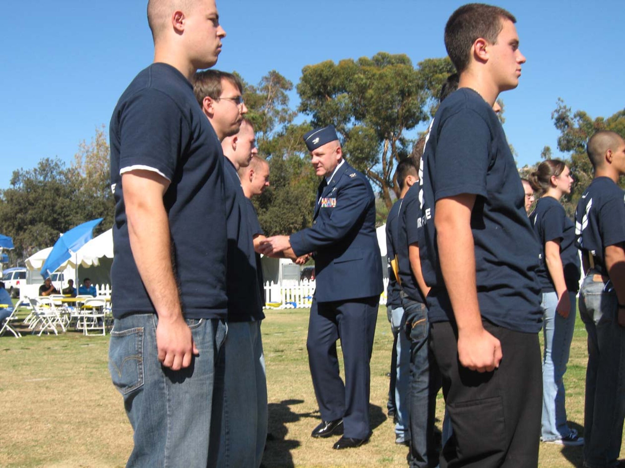 Col. Jeffery Robertson congratulates 19 Air Force recruits after he gave them the Oath of Office during a swearing-in ceremony at the UCLA/Oregon State football game November 8, 2008, at the Rose Bowl in Pasadena, Calif.  Col. Robertson, Director of Staff, 4th Air Force, March Air Reserve Base,  officiated the ceremony as part of Air Force Week Los Angeles.  (USAF photo/Capt. Bruce Hill) (Released)