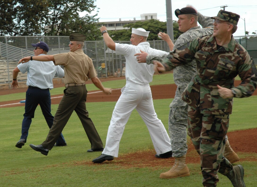 Senior Master Sgt. Mark, Avery, an Air Force Reservist with the 624th Regional Support Group, along with representatives of the four other uniformed services threw out a ceremonial first pitch for the Hawaii Winter Baseball League Nov. 9 at the Hans L'Orange Field, Waipahu, Hawaii. (U. S. Air Force photo/Master Sgt. Daniel Nathaniel)