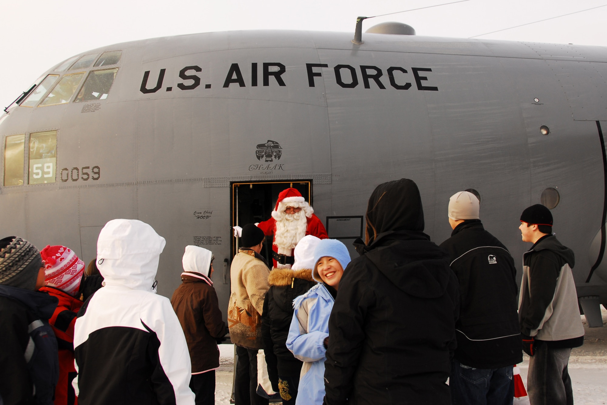 RUBY, Alaska -- Santa steps off an Alaska Air National Guard C-130 Hercules here to meet a crowd of excited students. For children of rural Alaska, Santa?s sleigh has come to resemble the Air National Guard's C-130 or the Alaska Army National Guard's UH-60 Black Hawk during Operation Santa Claus. (U.S. Army photo/Kalei Brooks)