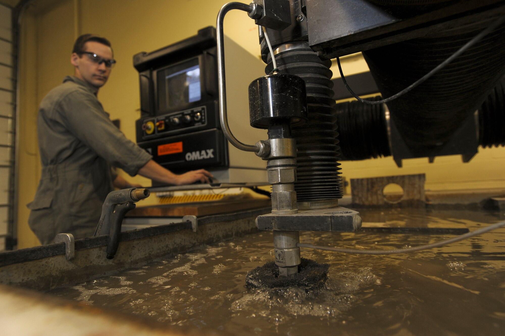 ELMENDORF AIR FORCE BASE, Alaska -- Staff Sgt. Bryce Bailey, 3rd Equipment Maintenance Squadron, uses the water cutter to fabricate a ring brace for the F-15 Eagle. The water cutter uses water and sand to cut through metal and create various parts for various aircraft and equipment. (U.S. Air Force photo/Staff Sgt. Joshua Garcia)