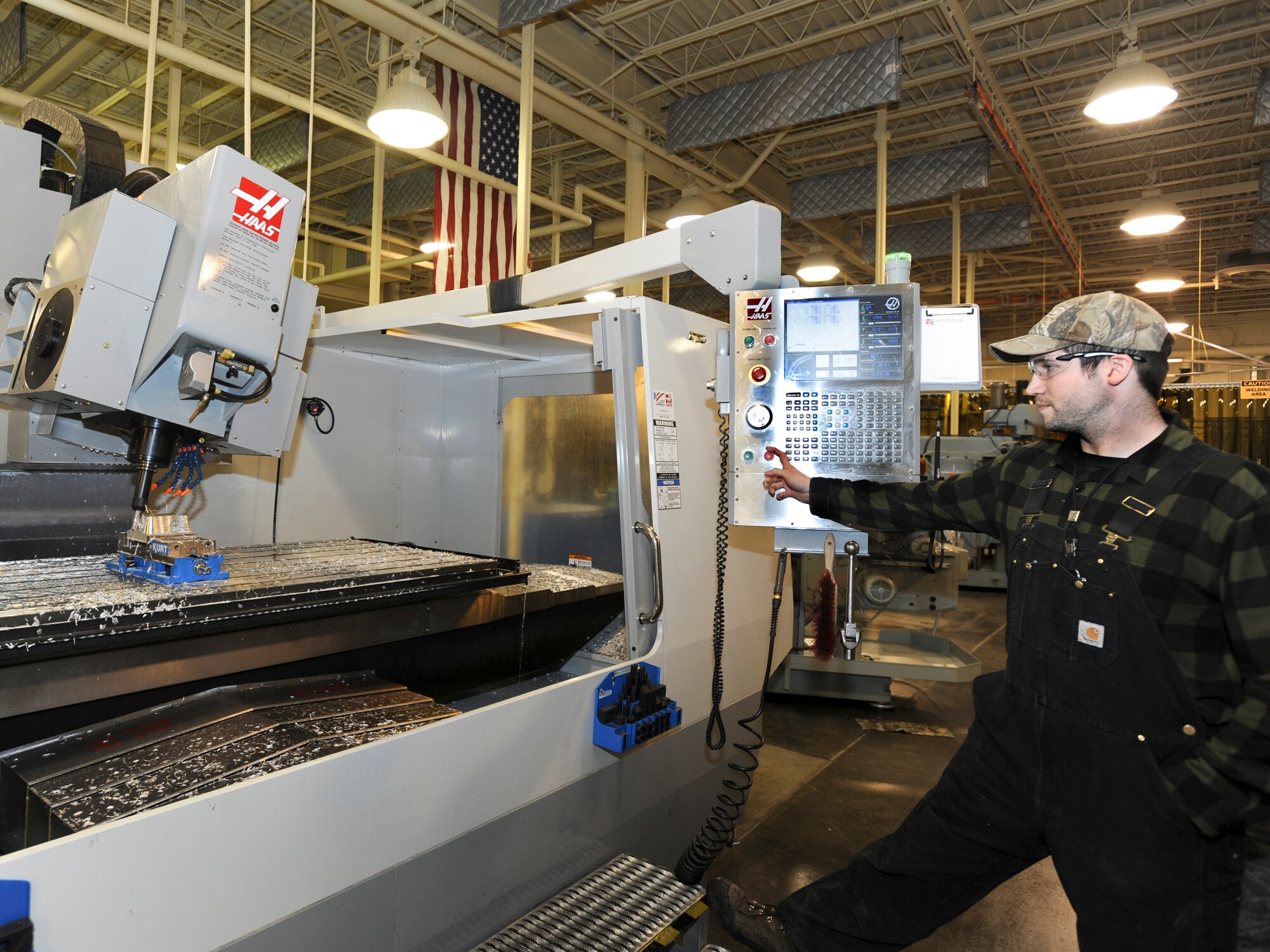 ELMENDORF AIR FORCE BASE, Alaska -- Edmond Kelleher, a 3rd Equipment Maintenance Squadron civilian employee, operates the 5-Axis to create a bathtub fitting for the F-15 Eagle. The bathtub fitting is used to prevent cracks and to keep them from spreading on the aircraft. Mr. Kelleher works alongside military members on Elmendorf. (U.S. Air Force photo/Staff Sgt. Joshua Garcia)