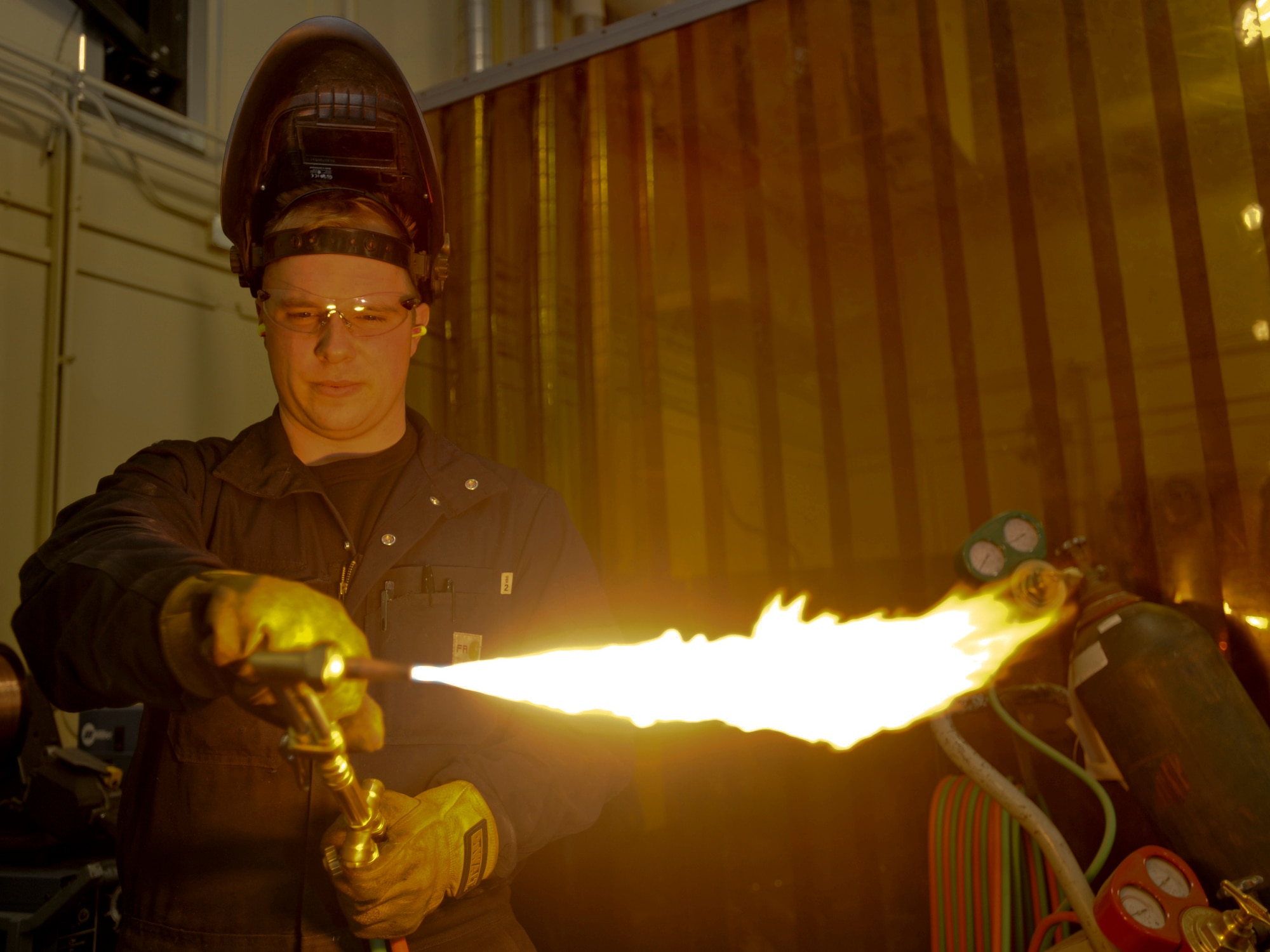 ELMENDORF AIR FORCE BASE, Alaska -- Staff Sgt. Barry Holland, 3rd Equipment Maintenance Squadron, preps an oxygen torch prior using to cut out a gusset for an aircraft stand here Nov. 5. Sergeant Holland and fellow members from the Metals Technology flight fabricate various pieces of equipment for aircraft and aerospace ground equipment. (U.S. Air Force photo/ Staff Sgt. Joshua Garcia)