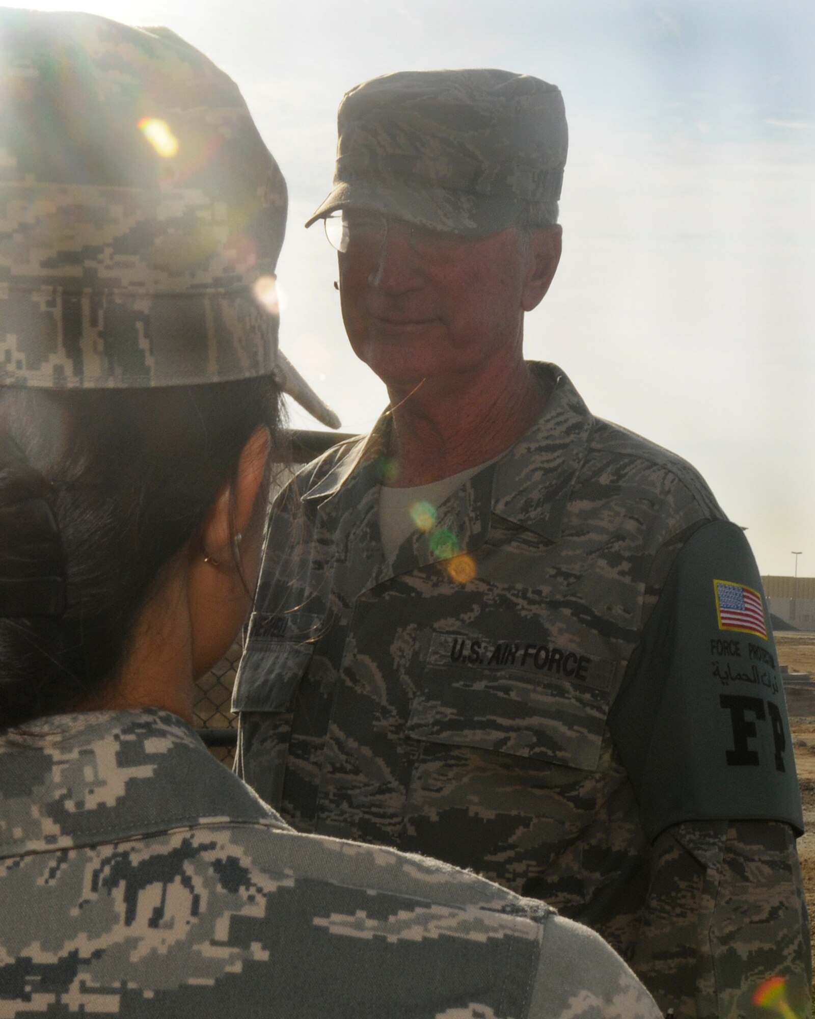 SOUTHWEST ASIA -- Senior Airman Danielle Peregrino, 380th Expeditionary Force Protection escort, gives a post briefing to Senior Master Sgt. Edgar Newell, 380th EFP superintendent, at the start of the day's first shift here Nov. 8. Sergeant Newell is ending his last deployment prior to his retirement after nearly 40 years of military service. (U.S. Air Force photo by Tech. Sgt. Christopher A. Campbell)(released)