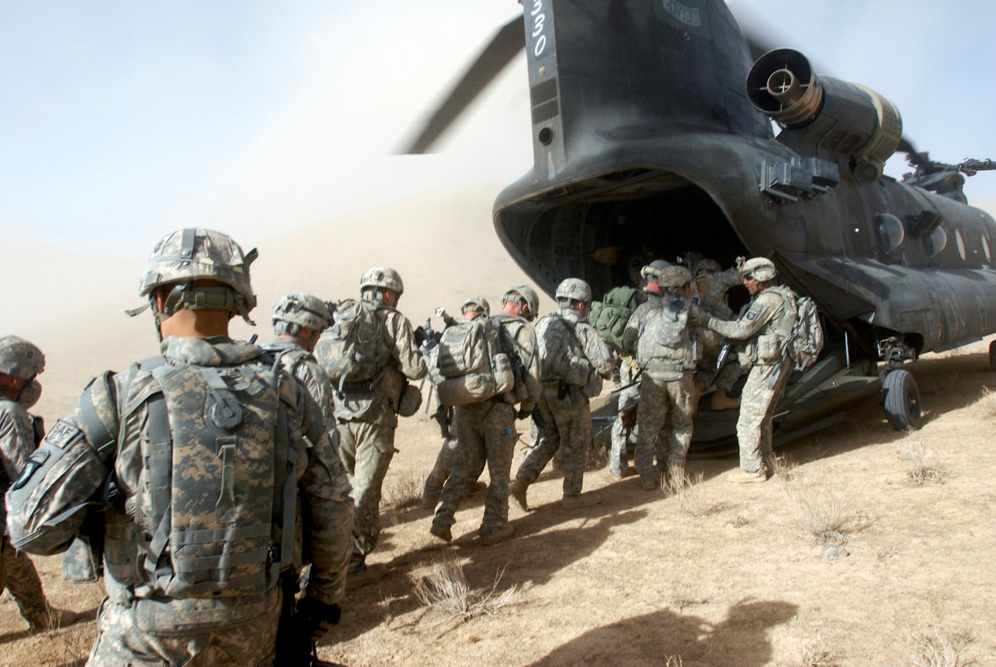 Like a stampede, Soldiers with the 101st Division Special Troops Battalion, 101st Airborne Division, rush into a Chinook helicopter as it briefly touches down to take them back to Bagram Air Field, Afghanistan Nov. 4, 2008.  The troops were conducting an air assault mission in a small village in eastern Afghanistan to search for IED making materials and facilities. (Photo by Spc. Mary L. Gonzalez, CJTF-101 Public Affairs)