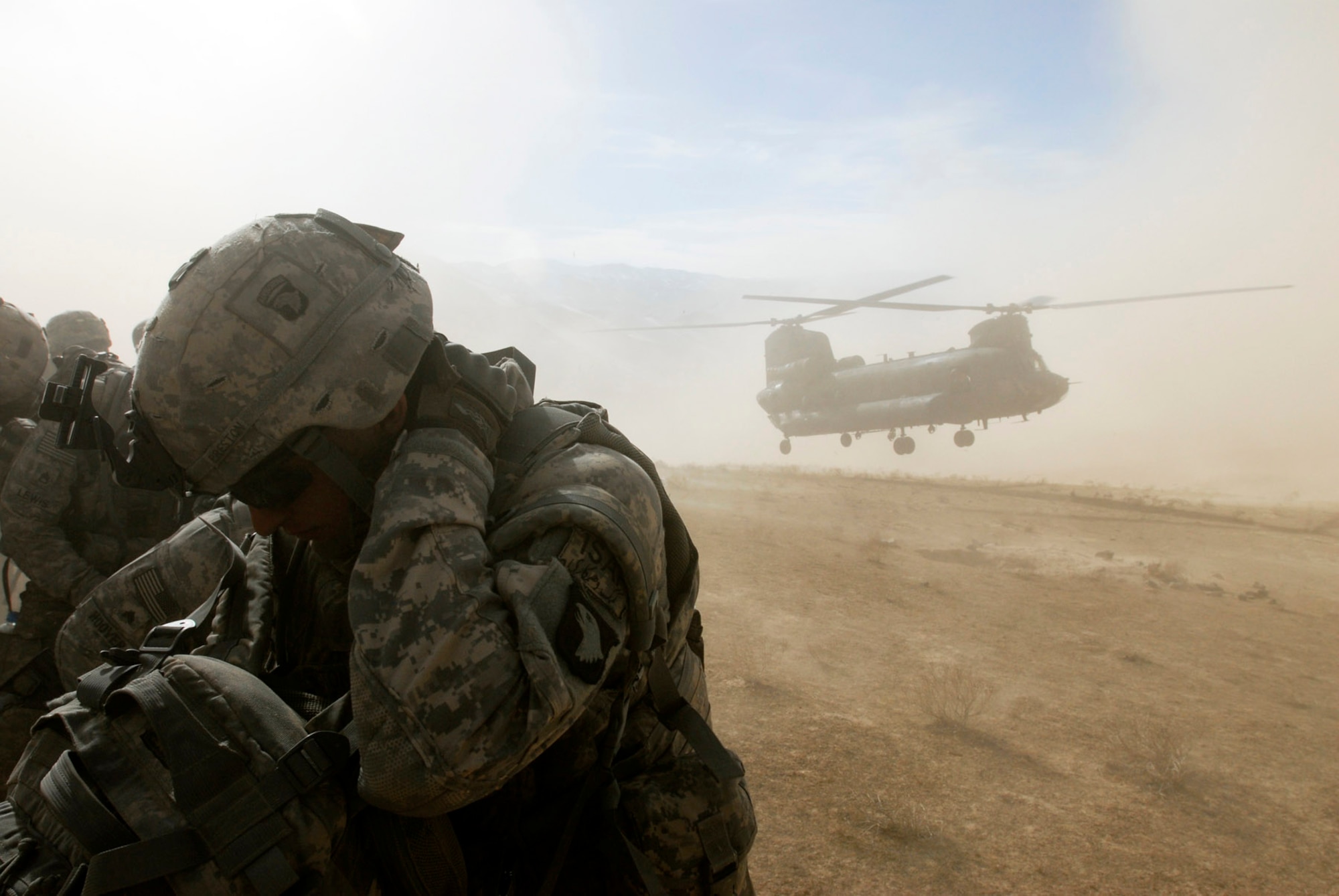 Soldiers with the 101st Airborne Division shield themselves from flying debris and dusty winds as a Chinook helicopter touches down to take them back to Bagram Air Field after an air assault mission in eastern Afghanistan Nov. 4, 2008. (Photo by Spc. Mary L. Gonzalez, CJTF-101 Public Affairs)