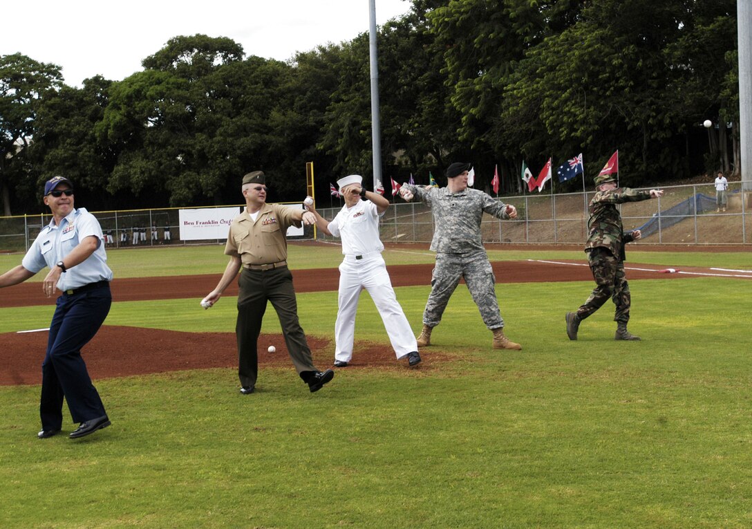 (From left to right) Coast Guard Petty Officer 1st Class Mike Daniels, Marine Chief Warrant Officer 4 Chris Doman, Navy Petty Officer 1st Class Ryne Mueller, Spc. Chris Palo and Air Force Master Sgt. Chris Avery throw out the first pitches at the Hawaii Winter Baseball league's military appreciation night Nov. 9. In appreciation for their service, the military representatives were treated to a shrimp dinner and a VIP view of the game.