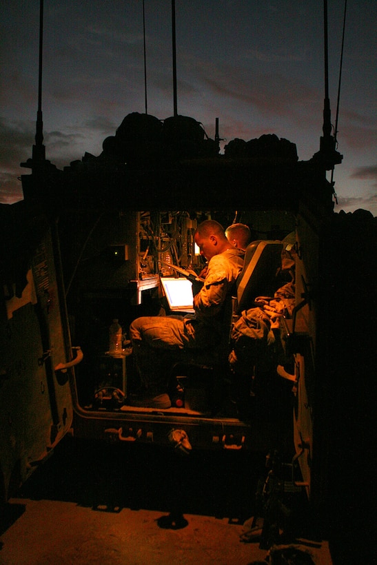 2nd Lt. Richard K. Sala, commander of 3rd Platoon, Company C, 1st Light Armored Reconnaissance Battalion reviews reconnaissance information near Sinjar Airfield here. After reconnaissance of the open area west of Mosul, the company patrolled through nearby wadis to assess routes and hiding places for foreign fighter facilitators moving weapons and insurgents in from Syria.::r::::n::::r::::n::