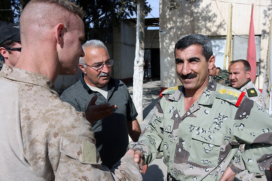Capt. Keith P. Tighe, commanding officer, Company D, 1st Light Armored Reconnaissance Battalion, 1st Marine Division, shakes hands with Col. Fathy Ismail Afdeo, commanding officer, 3rd Battalion, 11 Brigade, 3rd Iraqi Army Division, prior to a meeting Nov. 10. Tighe, 39, Sacramento, Calif., and the “Diablos” of Company D accepted responsibility for battle space in the Nineweh province Nov. 10. The Marines relieved soldiers from the Army’s 3rd Armored Cavalry Regiment. Mission accomplishment for the Diablos is to enable stabilization of Mosul by maintaining presence in towns, villages and along trade routes used by foreign fighter facilitators and insurgents. The Marines make up one element of the first Marine Air Ground Task Force outside Anbar in Iraq since 2004. They traveled to the Nineweh province to kick off Operation Defeat Al Qaeda in the North II, an operation aimed at stamping out the insurgency just west of the restive city of Mosul.