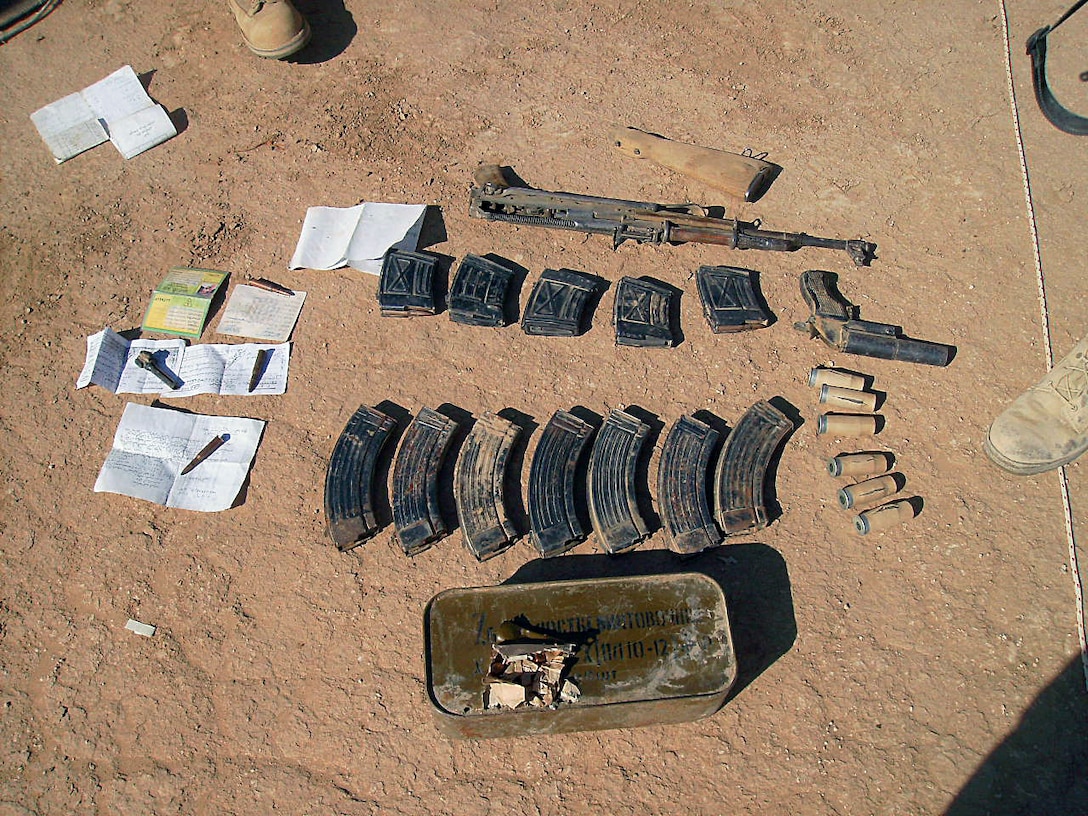 The military police of MP detachment, Combat Logistics Company 19, 1st Marine Logistics Group discovered a small weapons cache in an abandoned town just one kilometer west of Camp Sinjar Nov. 11. The cache consisted of an AK-47, a flare gun, ammunition for the AK and ammunition for a Dragonov sniper rifle. There was no Draganov sniper rifle onsite. The Marines also found numerous papers with Arabic writing, a bag full of syringes, and vials containing an unknown liquid. Marines suspect that the papers may be possible intelligence on the enemy and that the liquid could be some kind of amphetamine, but investigators have yet to make any conclusions. Marines in MP detachment make up one part of the first Marine Air Ground Task Force outside Anbar in Iraq since 2004. They traveled to the Nineweh province to kick off Operation Defeat Al Qaeda in the North II, an operation aimed at stamping out the insurgency just west of the restive city of Mosul.