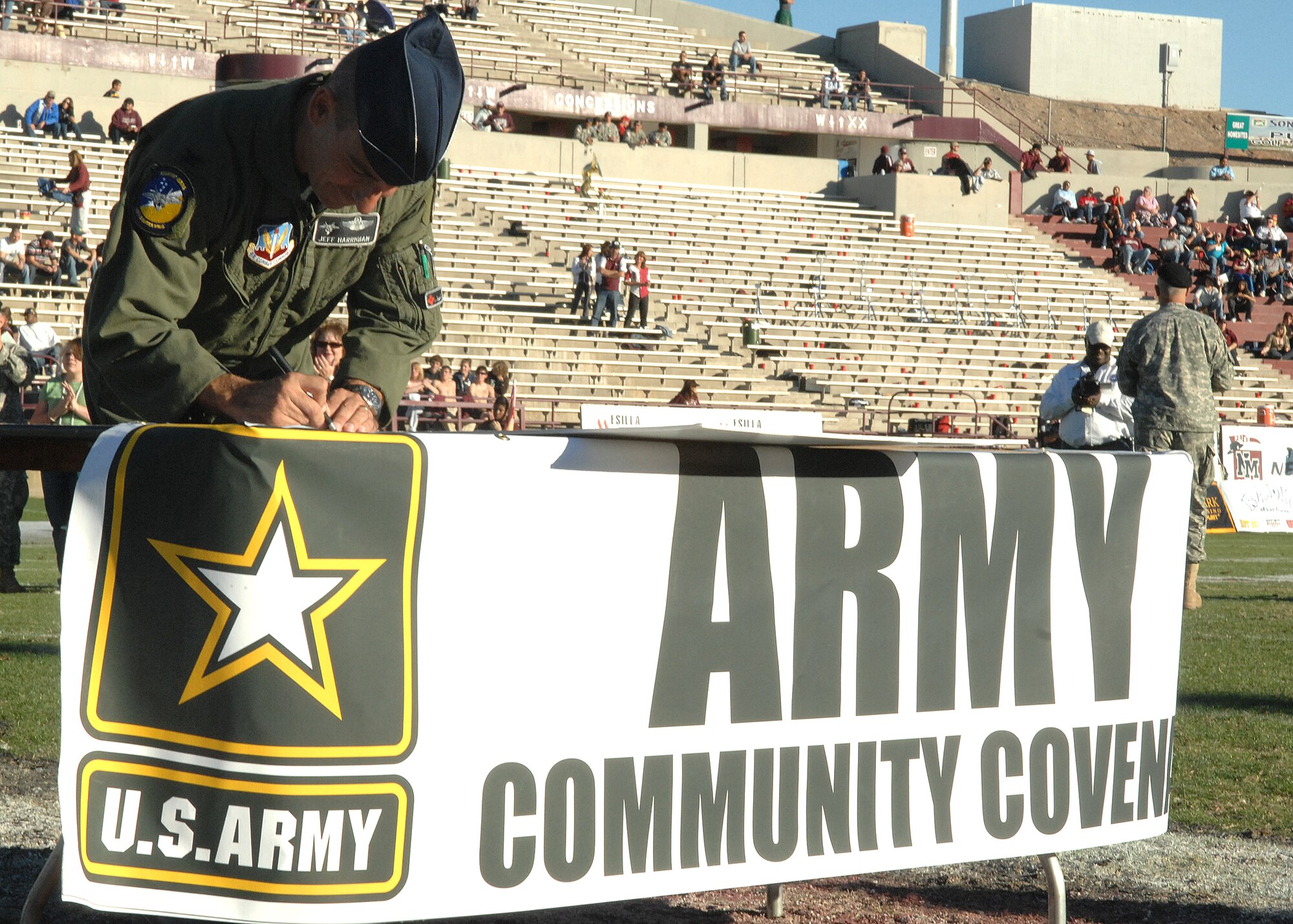 Col. Jeff Harrigian, 49th Fighter Wing commander at Holloman Air Force Base, N.M., signs the Army Community Covenant, Nov. 8, at New Mexico State University in Las Cruces, N.M. The Army Community Covenant is designed to develop and foster effective state and community partnerships with the Army in improving the quality of life for Soldiers and their families, both at their current duty stations and as they transfer from state to state.  (U.S. Air Force photo by Airman 1st Class John D. Strong II)